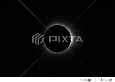 A bright solar eclipse with a shining crown on a black background. Space for text. A bright solar eclipse with a shining crown on a black background. Space for text. 129179856