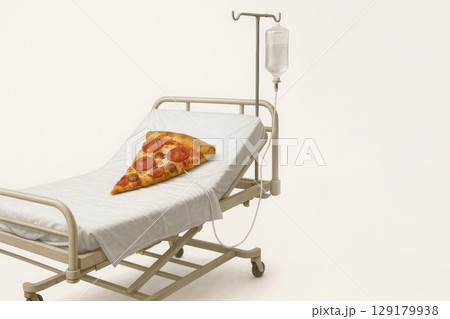 Pizza on a hospital bed with a drip. Space for text. 129179938