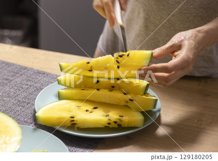Close up shot of the cut watermelon with yellow flesh on ceramic plate Close up shot of the cut watermelon with yellow flesh on ceramic plate 129180205