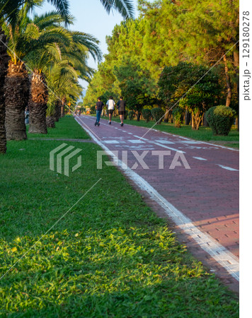 Bike lane concept. Healthy lifestyle. Urban space in a modern resort. Smart urbanism. Bicycle path close-up. Bike lane concept. Healthy lifestyle. Urban space in a modern resort. Smart urbanism. Bicycle path close-up. 129180278