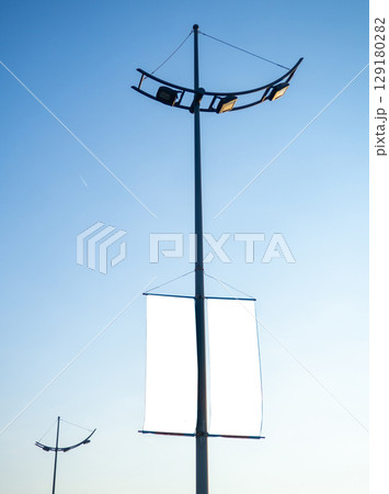 Advertising on a lamppost. Mocap against the sky. Place for advertising on a pole. Product promotion Advertising on a lamppost. Mocap against the sky. Place for advertising on a pole. Product promotion 129180282