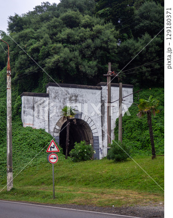 Railway tunnel in a picturesque place. Tunnel in the mountain. Railway tunnel in a picturesque place. Tunnel in the mountain. 129180371