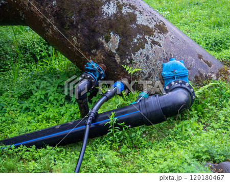 Valves on the gas pipeline. Gas cover. Transportation of fuel through the pipe. Village gas supply. Industry.  Embedded new line into old pipe 129180467