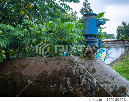 Valves on the gas pipeline. Gas cover. Transportation of fuel through the pipe. Village gas supply. Industry.  Embedded new line into old pipe 129180468