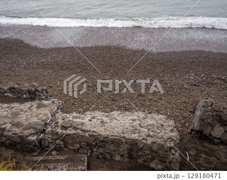 Old blocks of fortifications of the coast. Concrete structures on the shore. Protection against storms, waves and avalanches. Old blocks of fortifications of the coast. Concrete structures on the shore. Protection against storms, waves and avalanches. 129180471