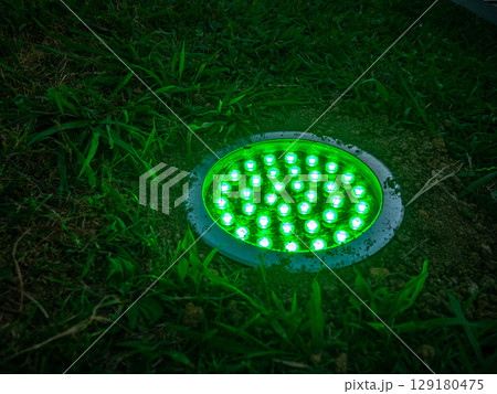 Turned on green light. Street illumination lamp in the ground. Lantern in the ground. Palm lighting. Turned on green light. Street illumination lamp in the ground. Lantern in the ground. Palm lighting. 129180475