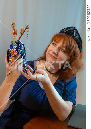 modern woman with elements of ethno-style in a costume uses the technique modern woman with elements of ethno-style in a costume uses the technique 129182330