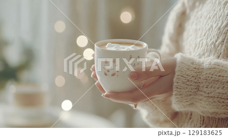 Hand holding white ceramic cappuccino cup with cute cat design, background 129183625