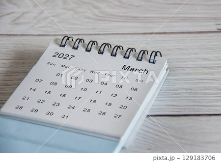 Close up of March 2027 calendar on wooden background Close up of March 2027 calendar on wooden background 129183706