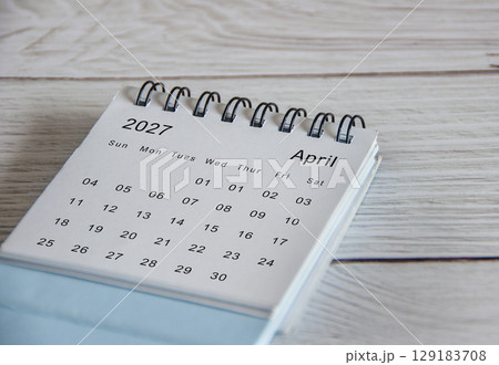 Close up of April 2027 calendar on wooden background Close up of April 2027 calendar on wooden background 129183708