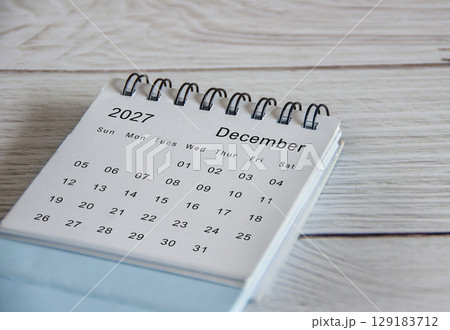Close up of December 2027 calendar on wooden background Close up of December 2027 calendar on wooden background 129183712