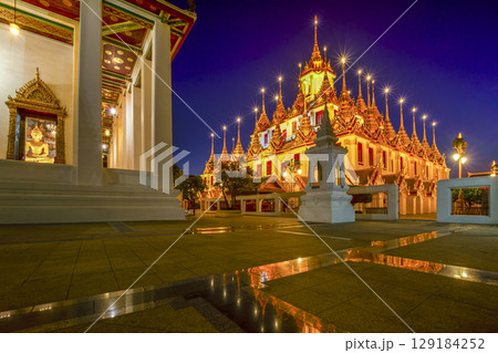 Beautiful sky and Wat Ratchanatdaram Temple in Bangkok, Thailand. Thai architecture: Wat Ratchanadda, Loha Prasat and Traditional Thai pavilion is among the best of Thailand's landmarks. 129184252