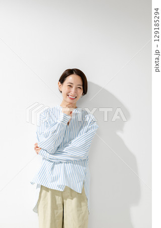 笑顔で立つミドル女性 129185294