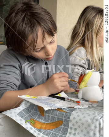 Children Painting Ceramic Figures Focused and Creative Children Painting Ceramic Figures Focused and Creative 129185351