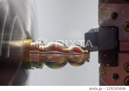 Close up scene the CNC lathe machine forming cutting the brass material shaft parts. 129185686