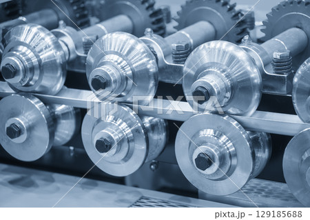 Close up scene the cold roll forming process in the blue tone. 129185688