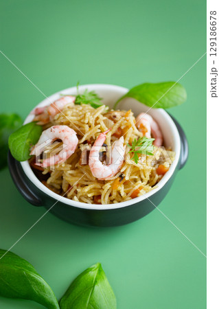 Appetizing rice with seafood and vegetable garnish 129186678