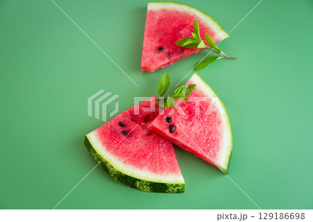 Summer refreshing still life with watermelon and green background Summer refreshing still life with watermelon and green background 129186698