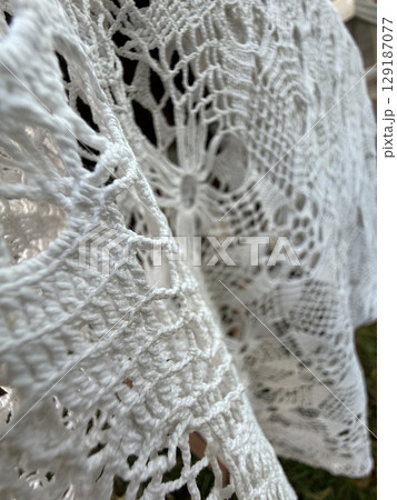 Crochet lace texture with intricate patterns. Suitable as background or for textile design 129187077