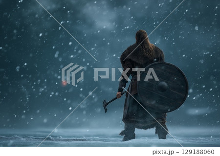 A battle-hardened Viking roars defiance amid the frozen wasteland's endless white 129188060