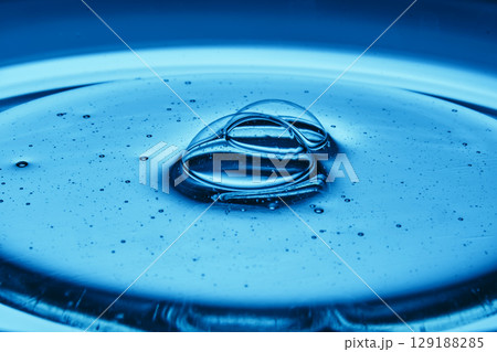 Mouth-watering bubbles in a drop of cosmetics in blue tones. Mouth-watering bubbles in a drop of cosmetics in blue tones. 129188285