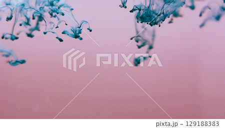 Blur color drip. Smoke splash. Turquoise blue dye blobs in defocused pink fluid. Paint pigment blend flow abstract background free space. 129188383