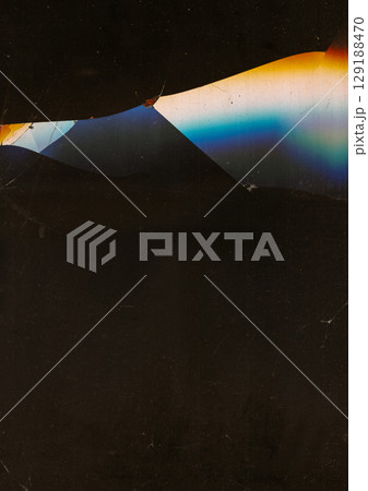 Broken display. Defocused old flare. Spectrum glow on cracked dark black background. Crashed techno glass device abstract texture. Broken display. Defocused old flare. Spectrum glow on cracked dark black background. Crashed techno glass device abstract texture. 129188470