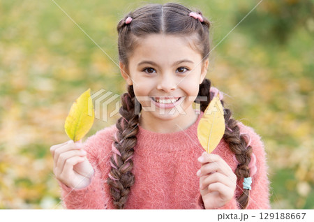 Small child with autumn leaves. Happy little girl in autumn forest. Happy childhood. School time. Autumn leaves and nature. Trendy beauty. Feeling comfortable. Time to rest. In love with nature Small child with autumn leaves. Happy little girl in autumn forest. Happy childhood. School time. Autumn leaves and nature. Trendy beauty. Feeling comfortable. Time to rest. In love with nature 129188667