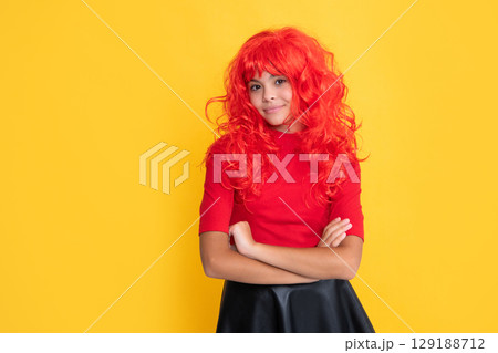 smiling teen kid with red long hair on yellow background 129188712