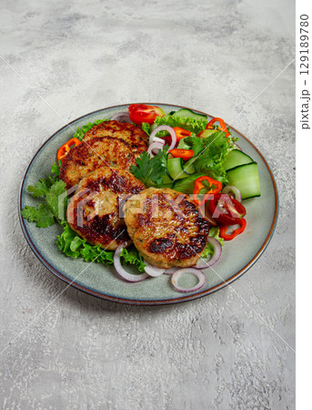 fried chicken cutlets, minced chicken, with vegetables, on gray , with vegetable salad, top view, homemade, no people, 129189780