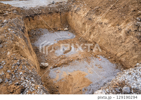 Plate load test results visible on soil surface after static pressure application. Ground investigation for foundation suitability and load-bearing capacity Plate load test results visible on soil surface after static pressure application. Ground investigation for foundation suitability and load-bearing capacity 129190294