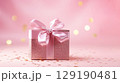 Holiday pink background with gift with satin bow. Valentine's Day, Women's Day, Mother's Day, Wedding, Christmas 129190481