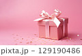 Holiday pink background with gift with satin bow. Valentine's Day, Women's Day, Mother's Day, Wedding, Christmas 129190486