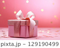 Holiday pink background with gift with satin bow. Valentine's Day, Women's Day, Mother's Day, Wedding, Christmas 129190499