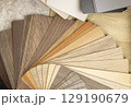 Samples of laminated chipboard. A range of gray and brown shades of wood-like boards. Concept of interior design and decor. 129190679