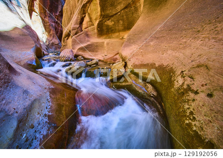 Slot Canyon Flowing Water and Sandstone Walls Eye Level Perspective Slot Canyon Flowing Water and Sandstone Walls Eye Level Perspective 129192056
