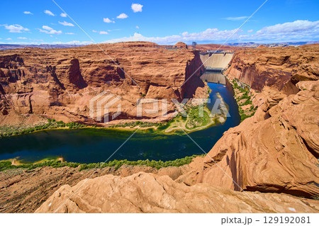 Glen Canyon Dam and Colorado River with Red Sandstone Cliffs Aerial Fly Over Glen Canyon Dam and Colorado River with Red Sandstone Cliffs Aerial Fly Over 129192081