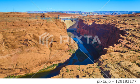 Aerial Glen Canyon Dam Colorado River and Red Sandstone Cliffs Fly Over View Aerial Glen Canyon Dam Colorado River and Red Sandstone Cliffs Fly Over View 129192177