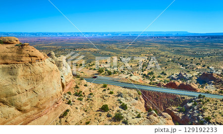 Aerial Fly Over Sandstone Cliff Desert Plain and Winding Road Marble Canyon 129192233
