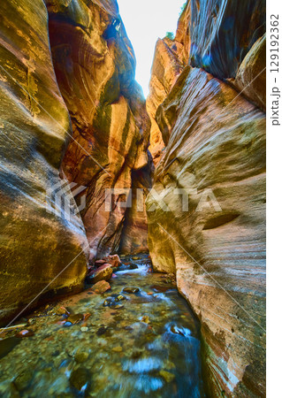 Sunlit Sandstone Slot Canyon Stream Motion Low Perspective 129192362