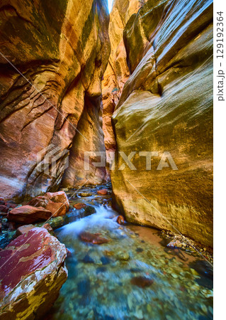 Sandstone Slot Canyon Stream Motion with Vertical Walls Low Perspective 129192364