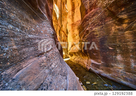 Sandstone Slot Canyon Walls with Flowing Stream and Sunlight Low Perspective Sandstone Slot Canyon Walls with Flowing Stream and Sunlight Low Perspective 129192388