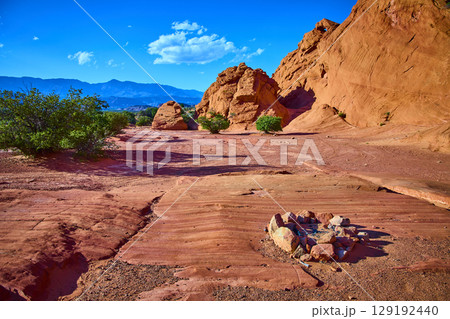 Red Sandstone Formations with Desert Fire Ring and Shrubs Eye Level Perspective Red Sandstone Formations with Desert Fire Ring and Shrubs Eye Level Perspective 129192440