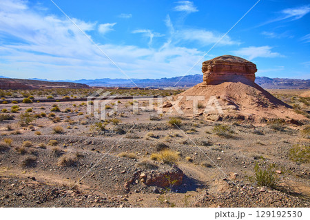 Majestic Desert Rock Formation Under Blue Sky Eye-Level Perspective Majestic Desert Rock Formation Under Blue Sky Eye-Level Perspective 129192530