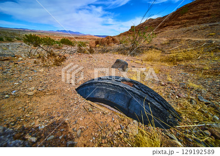 Abandoned Tire in Desert Landscape Low Ground Perspective 129192589