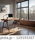 朝の自然光が差し込むオフィスで、デスクの上にノートパソコンが置かれている 129193267