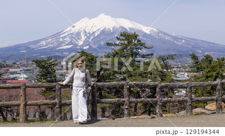 woman have a view in front of Mount Iwaki, it is the highest mountain in Aomori Prefecture, Japan	 129194344