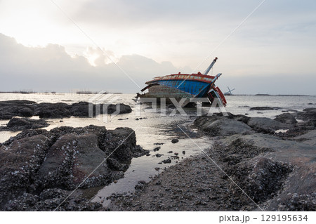 Old wrecked fishing boat on coast of Ang Sila Village, Saensuk Sub-district, Chonburi Province of thailand. 129195634