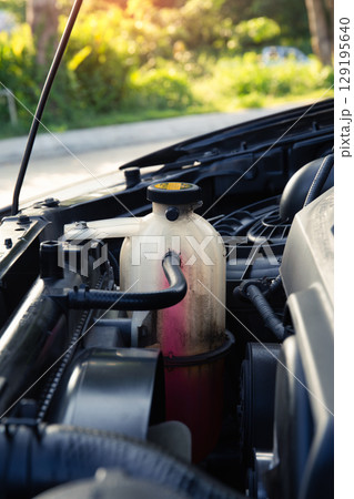 Coolant fluid and bottle in engine bay suit for concept of auto service check. Coolant fluid and bottle in engine bay suit for concept of auto service check. 129195640