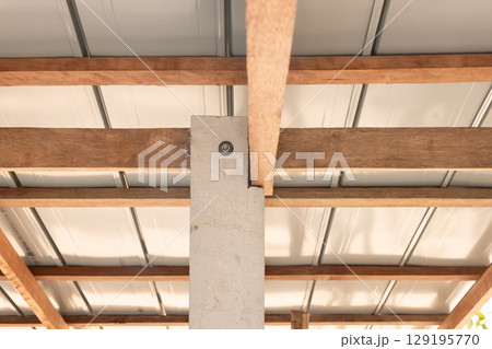 Roof under construction with metal sheet and wood structure. Roof under construction with metal sheet and wood structure. 129195770